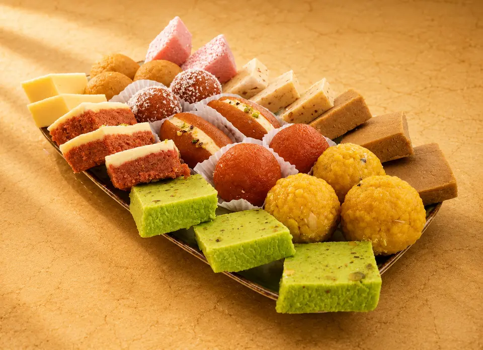 Mixed sweet platter with assorted barfi, ladoo and pista squares